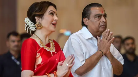 EPA Reliance Industries chairman Mukesh Ambani (R) and his wife Neeta Ambani gesture during a mass wedding ceremony for underprivileged couples at Reliance Corporate Park, in Navi Mumbai, India, 02 July 2024