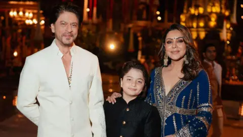 Reuters Actor Shah Rukh Khan, his wife Gauri and their son AbRam pose during the pre-wedding celebrations of Anant Ambani, son of Mukesh Ambani and Radhika Merchant, daughter of industrialist Viren Merchant, in Jamnagar, Gujarat, India