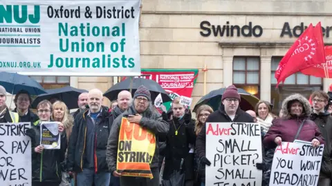 Getty Images Members of the NUJ, the National Union of Journalists and their supporters strike outside the offices of the Swindon Advertiser in January 2018