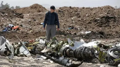 Reuters American civil aviation and Boeing investigators search through the debris at the scene of the Ethiopian Airlines Flight ET 302 plane crash