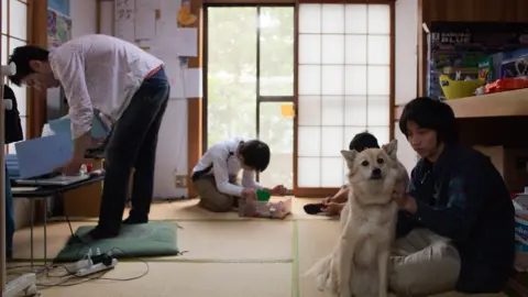 Stephane Bureau du Colombier A dog hangs out with pupils at Tamagawa Free School