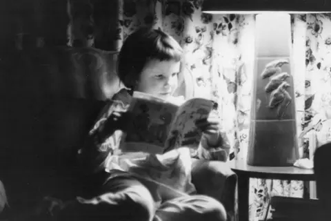 Kathy Sullivan A black and white photograph shows Kathy reading a comic book or other sort of magazine