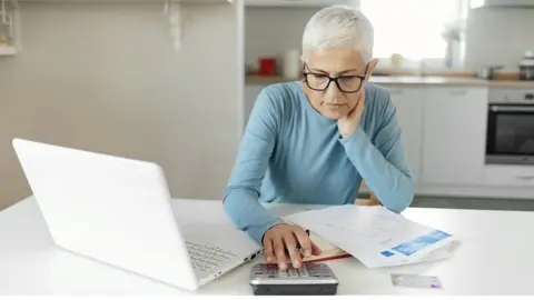 Getty Images A woman using a calculator