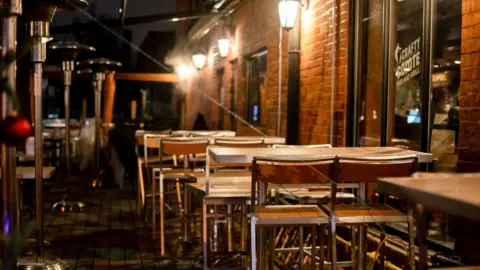 LightRocket via Getty Images A restaurant patio sits empty due to covid lockdown measures
