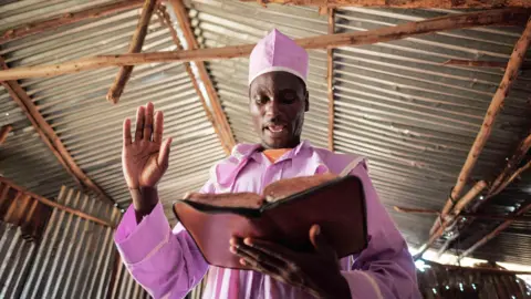 AFP A worshipper of Adundo Messiah church reads the Bible during the Sunday church service in Kisumu, Kenya