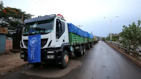 Reuters World Food Programme (WFP) convoy trucks carrying food items for the victims of Tigray war are seen parked after the checkpoints leading to Tigray Region were closed, in Mai Tsebri town, Ethiopia June 26, 2021