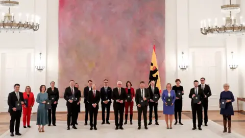 EPA German President Frank-Walter Steinmeier (C) and newly appointed Ministers pose for the media during the appointment of the Federal Ministers at the Bellevue Palace in Berlin, Germany, 08 December 2021