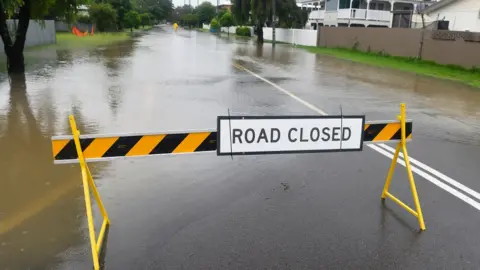 Getty Images Warning sign on a flooded road in the suburb of Railway Estate on February 01, 2019 in Townsville, Australia. Queensland