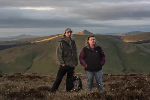 Joanne Coates Kirstie with her husband Kevin and Border Collie dog on the Cheviot Hills