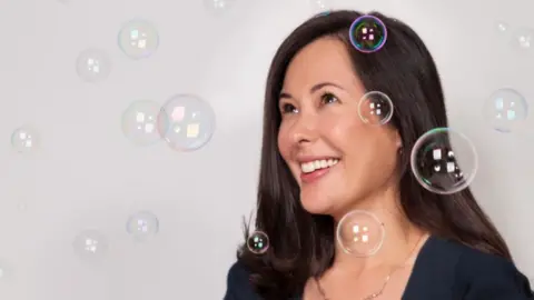 Billie Georgina Gooley smiles as bubble float around her
