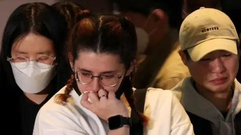 Reuters People react near the scene of the crush