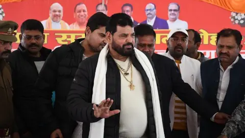 Getty Images Wrestling Federation of India (WFI) president Brij Bhushan Sharan Singh (C) arrives to address a press conference on 20 January
