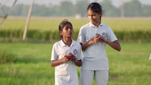 Simran practicing bowling at the field