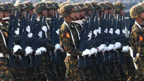 Getty Images Members of the Myanmar military take part in a parade to mark the country's 78th Armed Forces Day in Naypyidaw on March 27, 2023.
