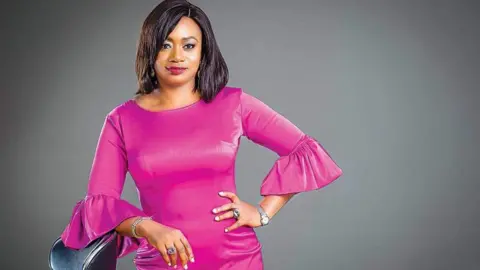 AISHA AHMAD/FACEBOOK Aisha Ahmad wearing a pink dress - one of the pictures that caused the storm