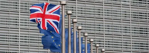 EPA A Union Jack flag flutters next to EU flags outside the European Commission