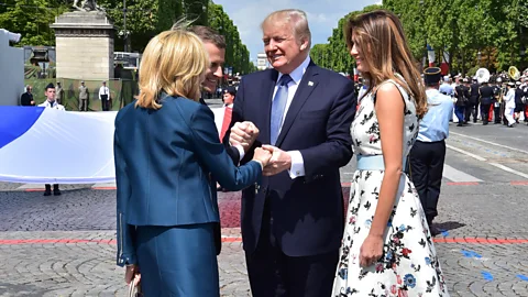 Getty Images Donald Trump and Emmanuel Macron's National Day Parade handshake turned into a bizarre three-way hand clasp (Credit: Getty Image)