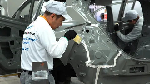 Nissan Yokohama-based car manufacturer Nissan employs craftsmen on their floor to do detailed work like apply sealant – and are teaching robots to do the same (Credit: Nissan)