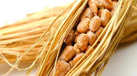 KPS/Getty Images Traditionally, the steamed soybeans were wrapped in rice straw to initiate the fermentation process (Credit: KPS/Getty Images)