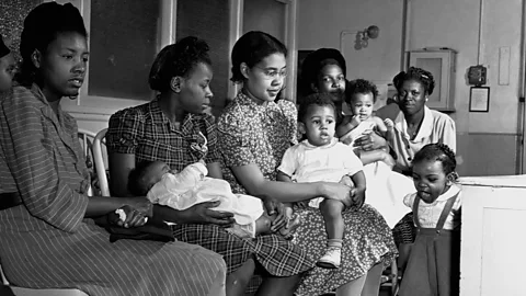 Getty Images Women and children wait in line at the Children's Hospital in Washington, DC in 1943; Dickens saw first-hand the racial disparities in care (Credit: Getty Images)