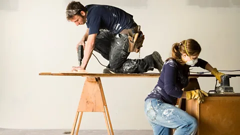 Getty Images A couple drilling and sanding wood (Credit: Getty Images)