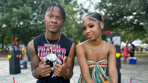 Brandon Drenon/BBC Shaun Gray sits next to his girlfriend at the Juneteenth celebration in Atlanta, Georgia