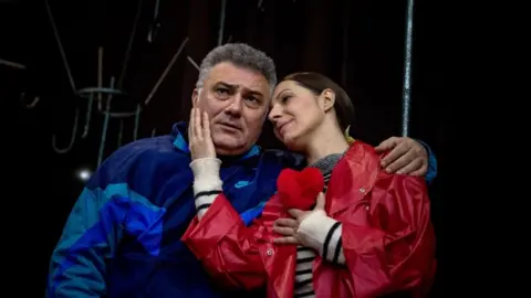 AFP Actress Ivana Kovacevic (R) as Mira Markovic, wife of former Serbian strongman Slobodan Milosevic, and actor Dejan Cicmilovic, as Milosevic perform on stage during a rehearsal of the play "Slobodan Show" in a theatre in Belgrade on 27 February 2018