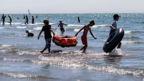 Getty Images kids play in the sea