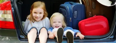 Getty Images Two young girls sat in a car