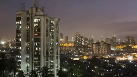 Reuters A high-rise residential tower is seen next to shanties in Dharavi, one of Asia"s largest slums, in Mumbai March 18, 2015. In Mumbai, the windows of new high-rise apartment blocks, old low-rise residential buildings and shantytown shacks portray the disparity in living conditions and incomes in the Indian city.