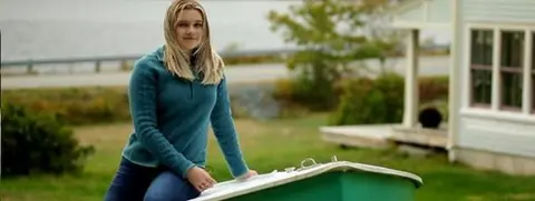 Stella Bowles sits on a boat in her garden