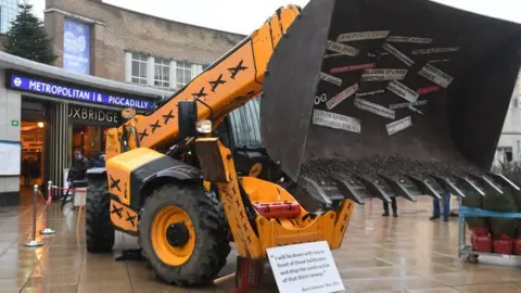 PA Media Protesters from Greenpeace with a vehicle outside Uxbridge tube station