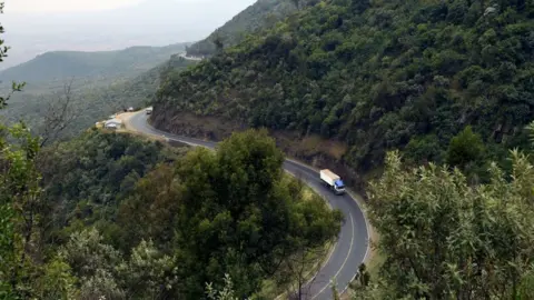 Getty Images A truck drives on August 21, 2019 on a section of a road leading down the eastern escarpment of the historic Rift Valley, snaking down the cliffside leading from Limuru town