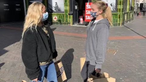 BBC Two women wearing masks and shopping