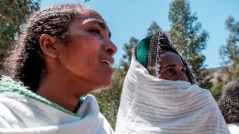AFP Women mourn the victims of a massacre allegedly perpetrated by Eritrean Soldiers in the village of Dengolat, North of Mekele, the capital of Tigray on February 26, 2021