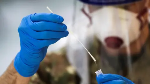 Reuters Healthcare staff holds Covid test