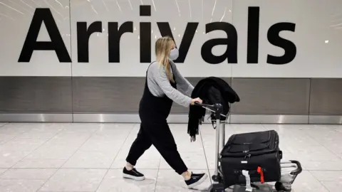 Getty Images People arrive at Heathrow's Terminal 5 in west London on August 2, 2021 as quarantine restrictions ease