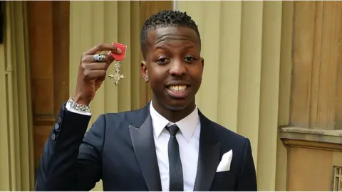 Getty Images Jamal Edwards holding his MBE