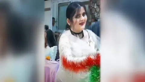 Family handout Video showing Mahsa Amini dancing at a wedding, waving a colourful shawl