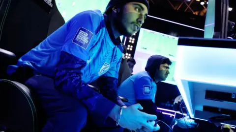 Getty Images Charanjot Singh, closest to the camera, playing for India at the FIFAe 2023 Nations Cup