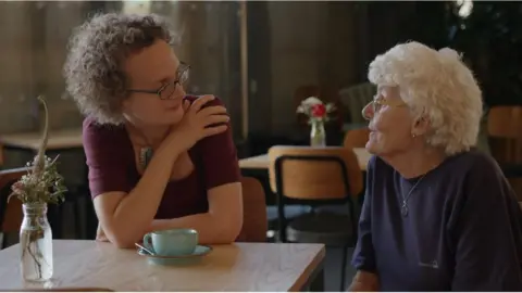 Bristol Women's Voice Two women talking over a cup of tea in a cafe