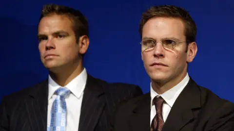Getty Images Lachlan and James Murdoch at The News Corporation's AGM in Adelaide, 9 October 2002.