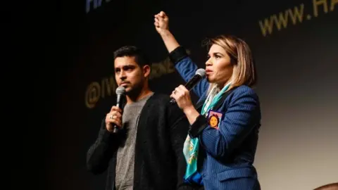 Harness Ferrera on stage at an event of her project Harness