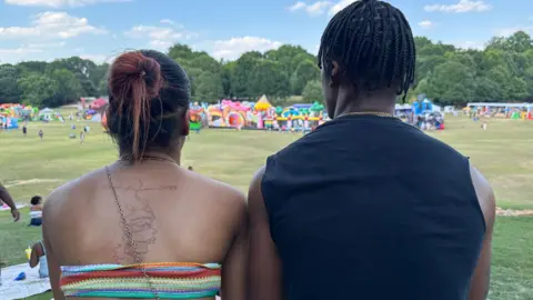 Brandon Drenon/BBC Shaun Gray and his girlfriend watch the Juneteenth celebrations in Atlanta, Georgia