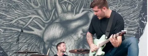 Getty Images Architects drummer Dan Searle playing with his twin brother Tom at Download Festival in 2013