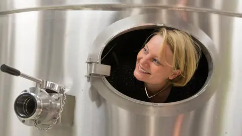 Jacquart Floriane Eznack peeks out from a large silver tank