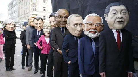 Getty Images Protesters dressed like the G20 leaders return backstage from their appearance during a demonstration against the upcoming G20 economic summit during a protest march on July 2, 2017 in Hamburg, Germany