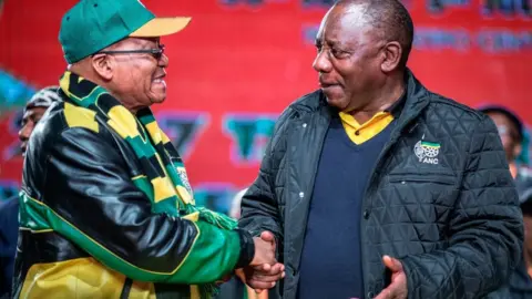 AFP South African President Jacob Zuma (L) and South African Deputy President Cyril Ramaphosa (R) shake hands as they arrive to attend the opening session of the South African ruling party African National Congress (ANC) policy conference on June 30, 2017 in Johannesburg.