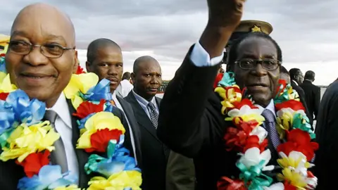 AFP South African President Jacob Zuma (L) and Zimbabwean counterpart Robert Mugabe are seen at Harare International Airport on March 16, 2010.