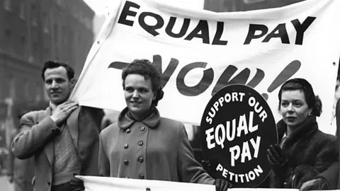 Getty Images This debate has been raging for decades: here, campaigners for equal pay gather outside Caxton Hall, London in 1954 (Credit: Getty Images)